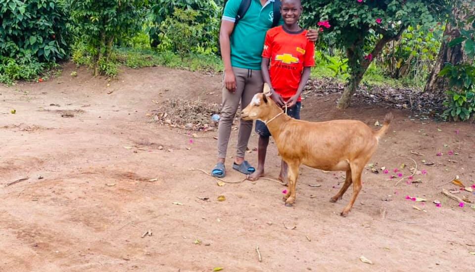 Kato Spencer receive a goat-Jk Arms For Charity